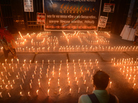 Former students of Ramkrishna Mission light candles as they take part in a protest to condemn the rape and murder of a young medic at RG Kar...