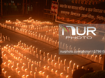 Former students of Ramkrishna Mission light candles as they take part in a protest to condemn the rape and murder of a young medic at RG Kar...