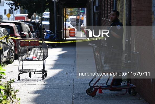 NYPD crime scene investigators search for evidence where a 32-year-old man is shot numerous times and killed in Manhattan, New York, United...