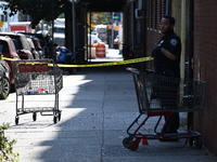 NYPD crime scene investigators search for evidence where a 32-year-old man is shot numerous times and killed in Manhattan, New York, United...