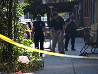 NYPD crime scene investigators search for evidence where a 32-year-old man is shot numerous times and killed in Manhattan, New York, United...