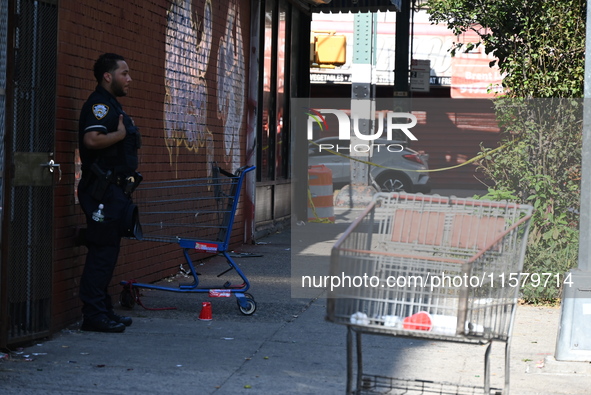 NYPD crime scene investigators search for evidence where a 32-year-old man is shot numerous times and killed in Manhattan, New York, United...