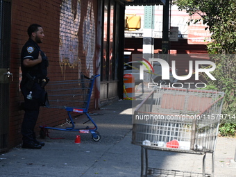 NYPD crime scene investigators search for evidence where a 32-year-old man is shot numerous times and killed in Manhattan, New York, United...