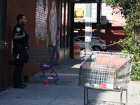 NYPD crime scene investigators search for evidence where a 32-year-old man is shot numerous times and killed in Manhattan, New York, United...