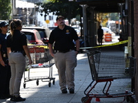 NYPD crime scene investigators search for evidence where a 32-year-old man is shot numerous times and killed in Manhattan, New York, United...