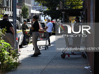 NYPD crime scene investigators search for evidence where a 32-year-old man is shot numerous times and killed in Manhattan, New York, United...