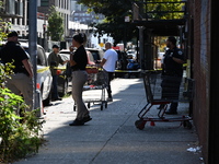 NYPD crime scene investigators search for evidence where a 32-year-old man is shot numerous times and killed in Manhattan, New York, United...