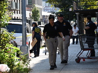 NYPD crime scene investigators search for evidence where a 32-year-old man is shot numerous times and killed in Manhattan, New York, United...