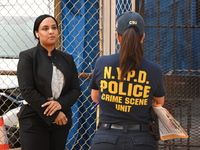 NYPD crime scene investigators search for evidence where a 32-year-old man is shot numerous times and killed in Manhattan, New York, United...