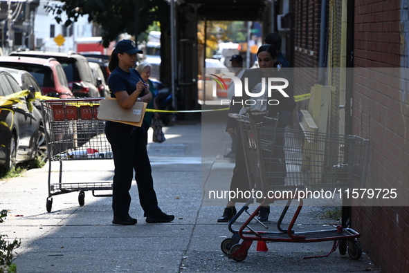 NYPD crime scene investigators search for evidence where a 32-year-old man is shot numerous times and killed in Manhattan, New York, United...