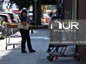 NYPD crime scene investigators search for evidence where a 32-year-old man is shot numerous times and killed in Manhattan, New York, United...