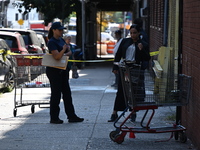 NYPD crime scene investigators search for evidence where a 32-year-old man is shot numerous times and killed in Manhattan, New York, United...