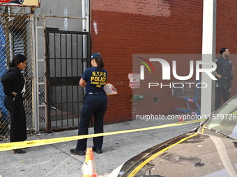 NYPD crime scene investigators search for evidence where a 32-year-old man is shot numerous times and killed in Manhattan, New York, United...