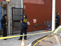 NYPD crime scene investigators search for evidence where a 32-year-old man is shot numerous times and killed in Manhattan, New York, United...