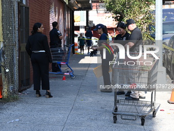 NYPD crime scene investigators search for evidence where a 32-year-old man is shot numerous times and killed in Manhattan, New York, United...