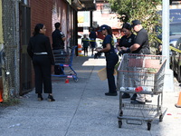 NYPD crime scene investigators search for evidence where a 32-year-old man is shot numerous times and killed in Manhattan, New York, United...