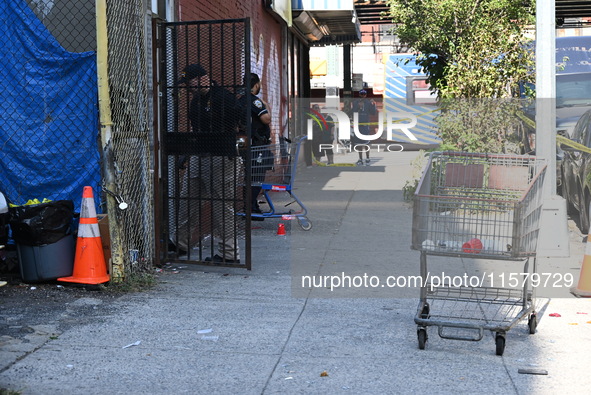 NYPD crime scene investigators search for evidence where a 32-year-old man is shot numerous times and killed in Manhattan, New York, United...