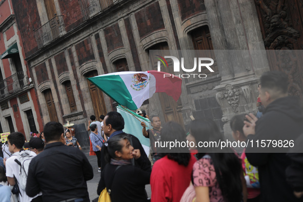 A person sells Mexican flags at Zocalo in the main square to celebrate the 214th Anniversary of Mexico's Independence Day in Mexico City, Me...