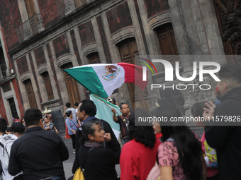 A person sells Mexican flags at Zocalo in the main square to celebrate the 214th Anniversary of Mexico's Independence Day in Mexico City, Me...