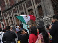 A person sells Mexican flags at Zocalo in the main square to celebrate the 214th Anniversary of Mexico's Independence Day in Mexico City, Me...