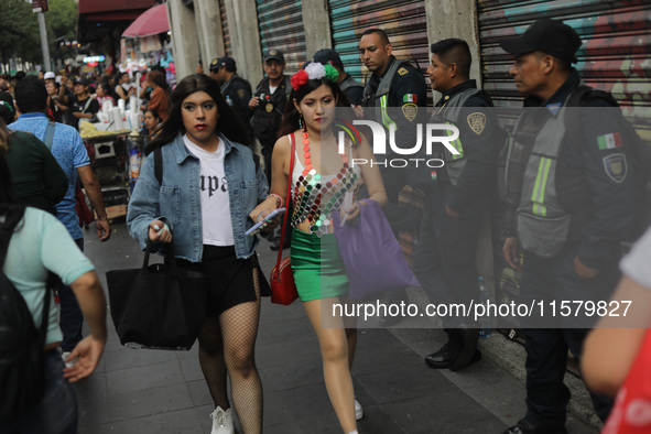 A woman wears clothing in the colors of the Mexican flag at Zocalo in the main square to celebrate the 214th Anniversary of Mexico's Indepen...