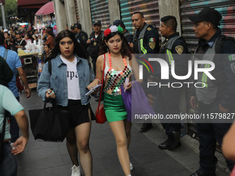 A woman wears clothing in the colors of the Mexican flag at Zocalo in the main square to celebrate the 214th Anniversary of Mexico's Indepen...