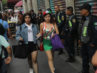 A woman wears clothing in the colors of the Mexican flag at Zocalo in the main square to celebrate the 214th Anniversary of Mexico's Indepen...