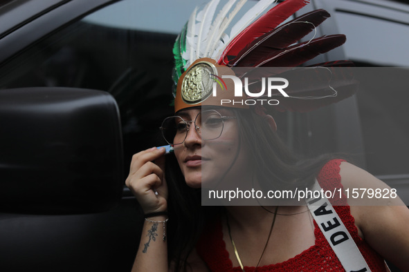 A woman wears a penacho with the colors of the Mexican flag at Zocalo in the main square to celebrate the 214th Anniversary of Mexico's Inde...