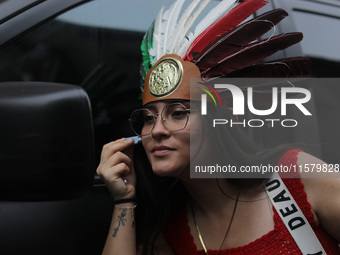 A woman wears a penacho with the colors of the Mexican flag at Zocalo in the main square to celebrate the 214th Anniversary of Mexico's Inde...