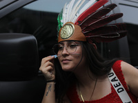 A woman wears a penacho with the colors of the Mexican flag at Zocalo in the main square to celebrate the 214th Anniversary of Mexico's Inde...