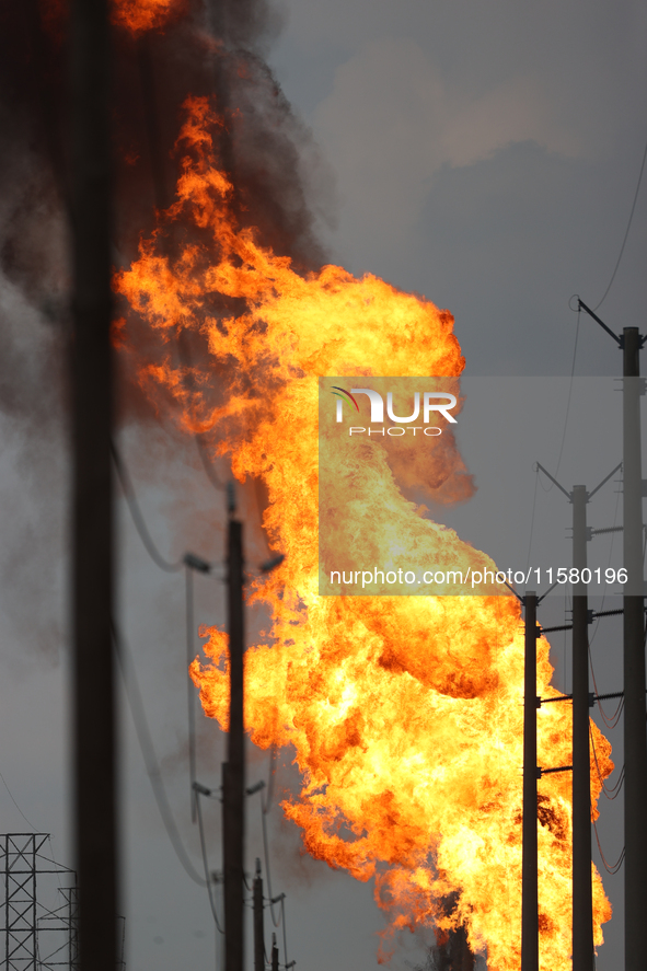 In Pasadena, Texas, a suburb of Houston, on September 16, 2024, a pipeline fire burns throughout the day. The fire can be seen up to twenty...