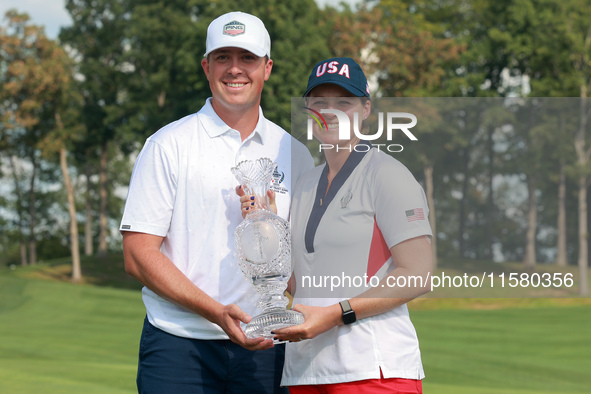 GAINESVILLE, VIRGINIA - SEPTEMBER 15: Ally Ewing of the United States poses with her significan other while holding the trophy on the 18th g...