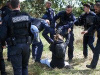 A Zadiste is pushed away by Gendarmes. After months of negotiations and pressures from NGE/Atosca, and two incendiary attacks, Alexandra, th...