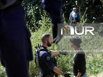 An opponent argues with a Gendarme. After months of negotiations and pressures from NGE/Atosca, and two incendiary attacks, Alexandra, the t...