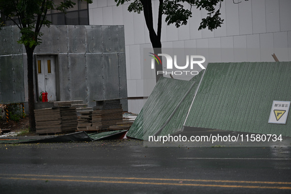 A fence is blown down at a construction site in Nanjing, China, on September 17, 2024. 