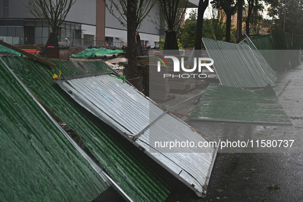 A fence is blown down at a construction site in Nanjing, China, on September 17, 2024. 