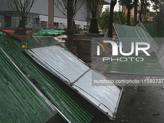 A fence is blown down at a construction site in Nanjing, China, on September 17, 2024. (