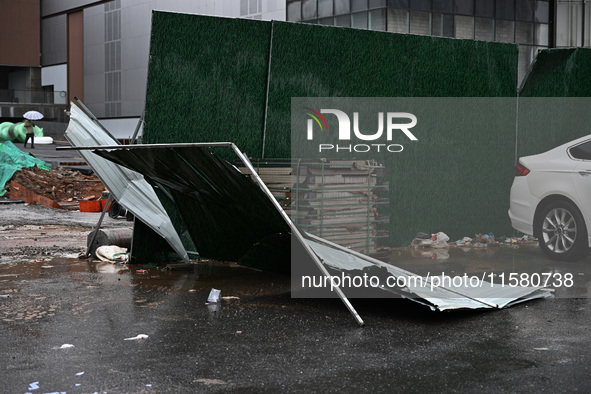 A fence is blown down at a construction site in Nanjing, China, on September 17, 2024. 