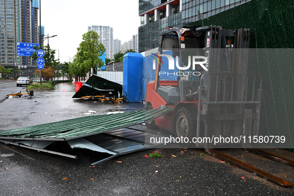 A fence is blown down at a construction site in Nanjing, China, on September 17, 2024. 