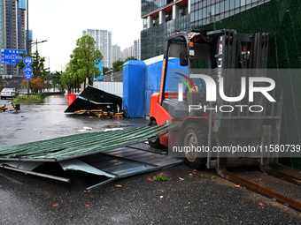 A fence is blown down at a construction site in Nanjing, China, on September 17, 2024. (