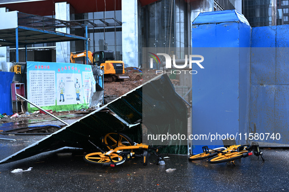 A fence is blown down at a construction site in Nanjing, China, on September 17, 2024. 