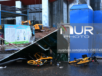 A fence is blown down at a construction site in Nanjing, China, on September 17, 2024. (