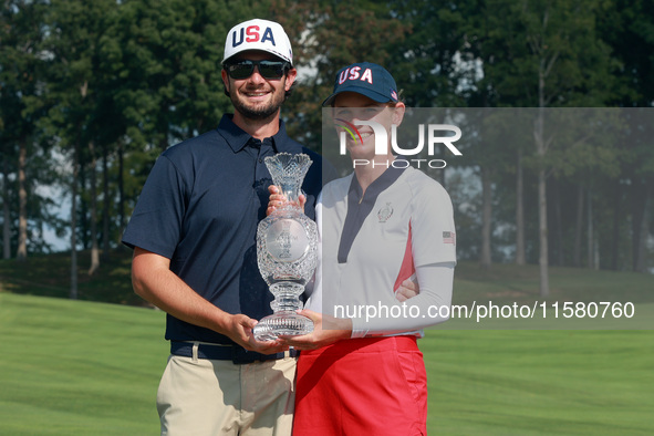 GAINESVILLE, VIRGINIA - SEPTEMBER 15: Sarah Schmelzel of the United States poses with her significant other while holding the trophy after a...