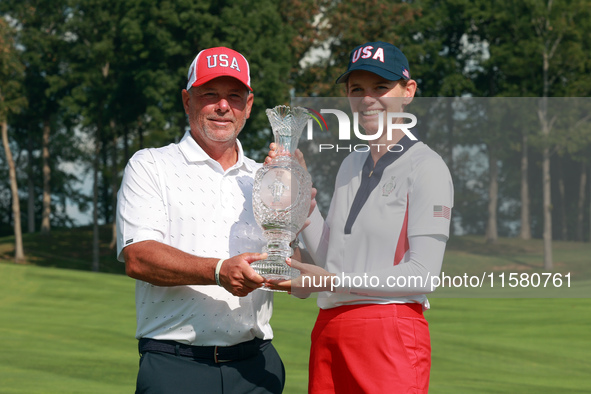 GAINESVILLE, VIRGINIA - SEPTEMBER 15: Sarah Schmelzel of the United States poses with her caddie while holding the trophy after a Team USA w...