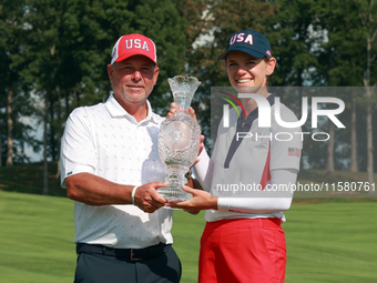 GAINESVILLE, VIRGINIA - SEPTEMBER 15: Sarah Schmelzel of the United States poses with her caddie while holding the trophy after a Team USA w...