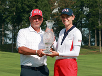 GAINESVILLE, VIRGINIA - SEPTEMBER 15: Sarah Schmelzel of the United States poses with her caddie while holding the trophy after a Team USA w...