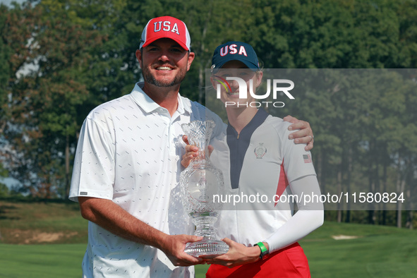 GAINESVILLE, VIRGINIA - SEPTEMBER 15: Nelly Korda of the United States poses with her caddie while holding the trophy after a Team USA win a...