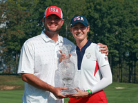 GAINESVILLE, VIRGINIA - SEPTEMBER 15: Nelly Korda of the United States poses with her caddie while holding the trophy after a Team USA win a...