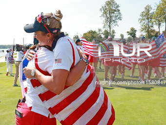 GAINESVILLE, VIRGINIA - SEPTEMBER 15: Lexi Thompson of the United States hugs Vice Captain Angela Stanford after a Team USA win the Solheim...