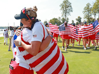 GAINESVILLE, VIRGINIA - SEPTEMBER 15: Lexi Thompson of the United States hugs Vice Captain Angela Stanford after a Team USA win the Solheim...